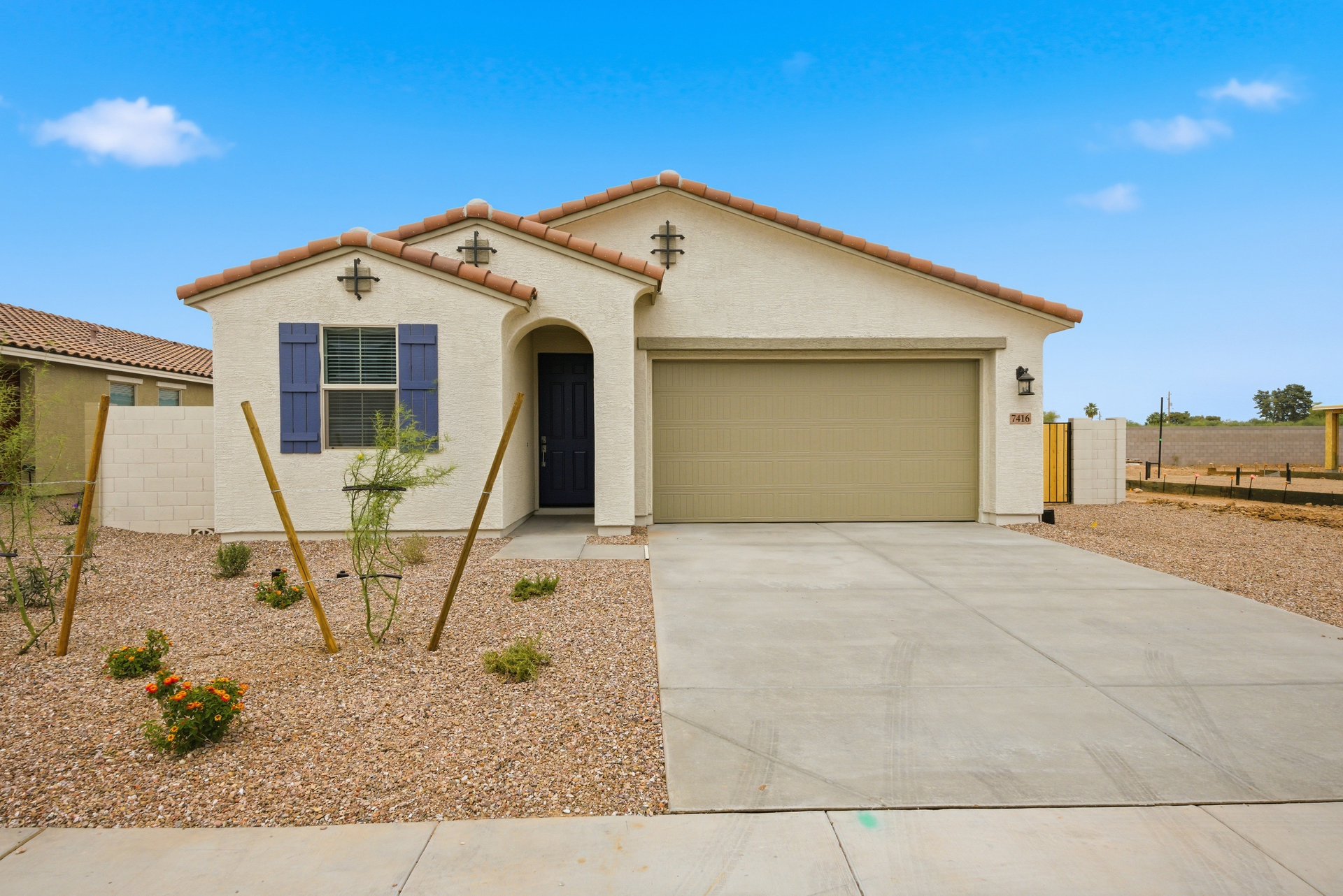 single-story single-family home with desert landscaping and concrete driveway