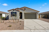 single-story single-family home with desert landscaping, a double gate, and a concrete driveway