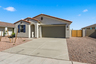 single-story single-family home with desert landscaping, a double gate, and a concrete driveway