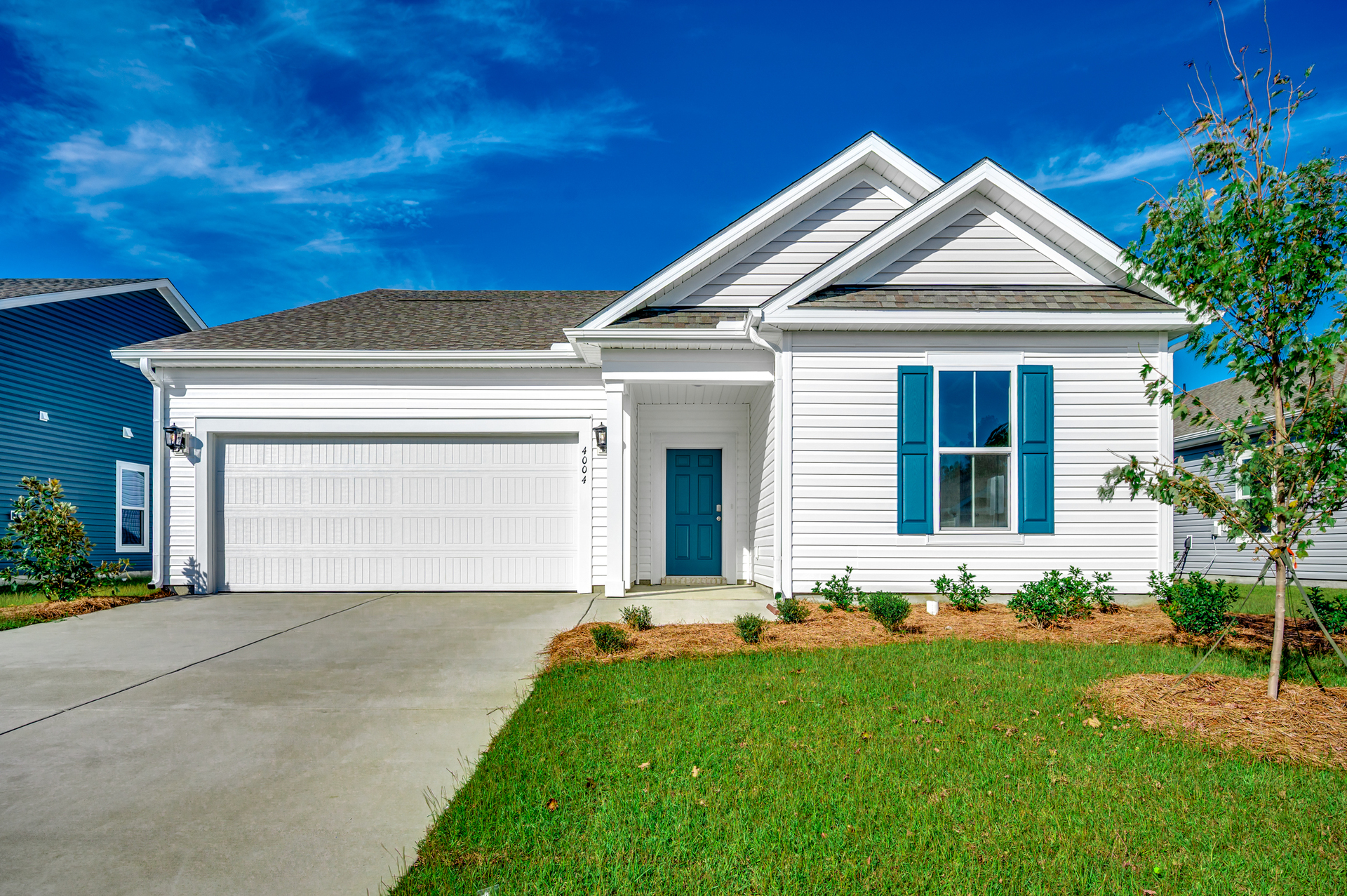 white vinyl exterior with blue door and shutters