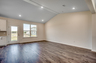 large windows for natural lighting, high ceilings with puck lighting and hardwood floors throughout