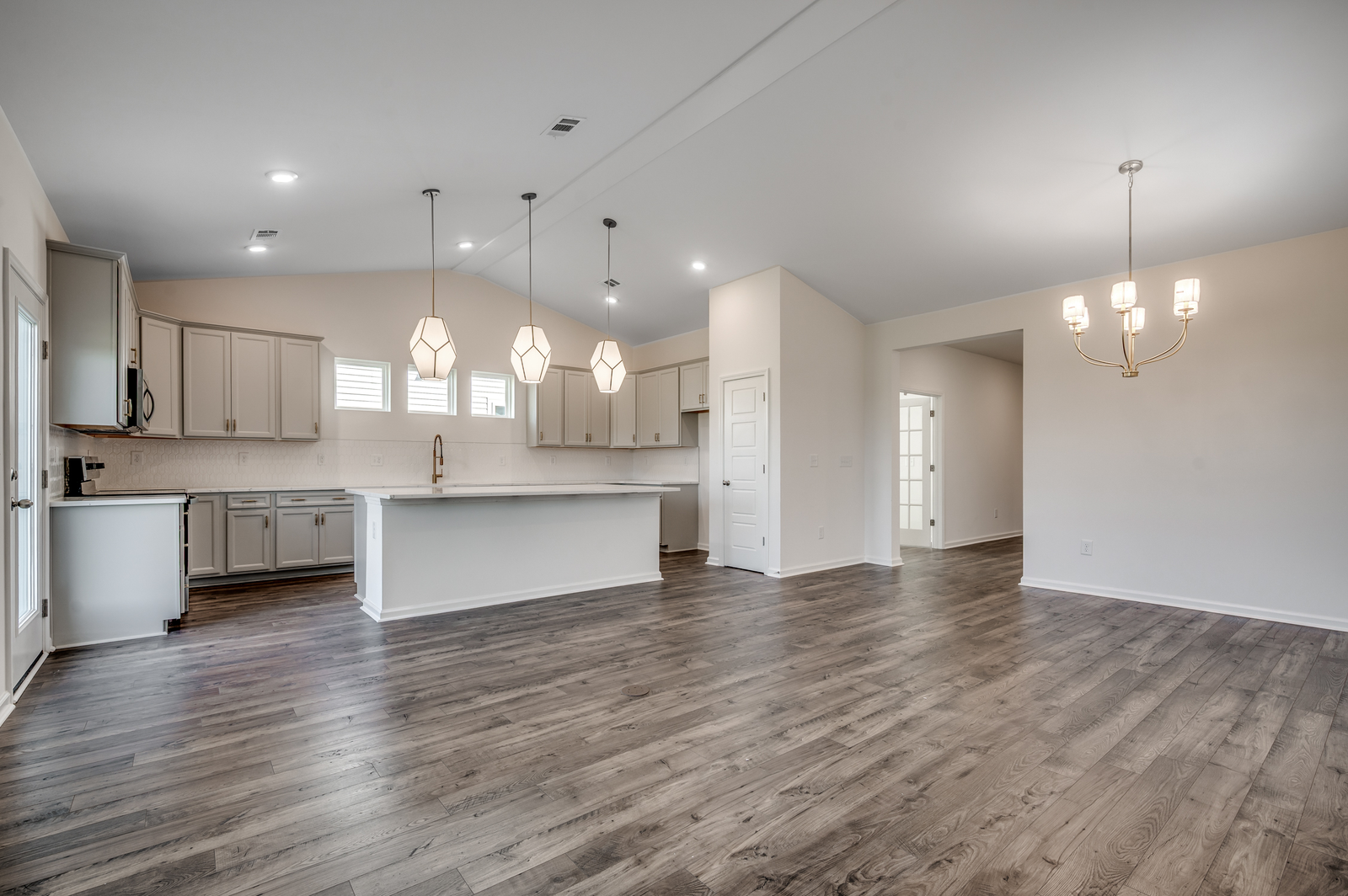 spacious room with high ceilings and hardwood flooring
