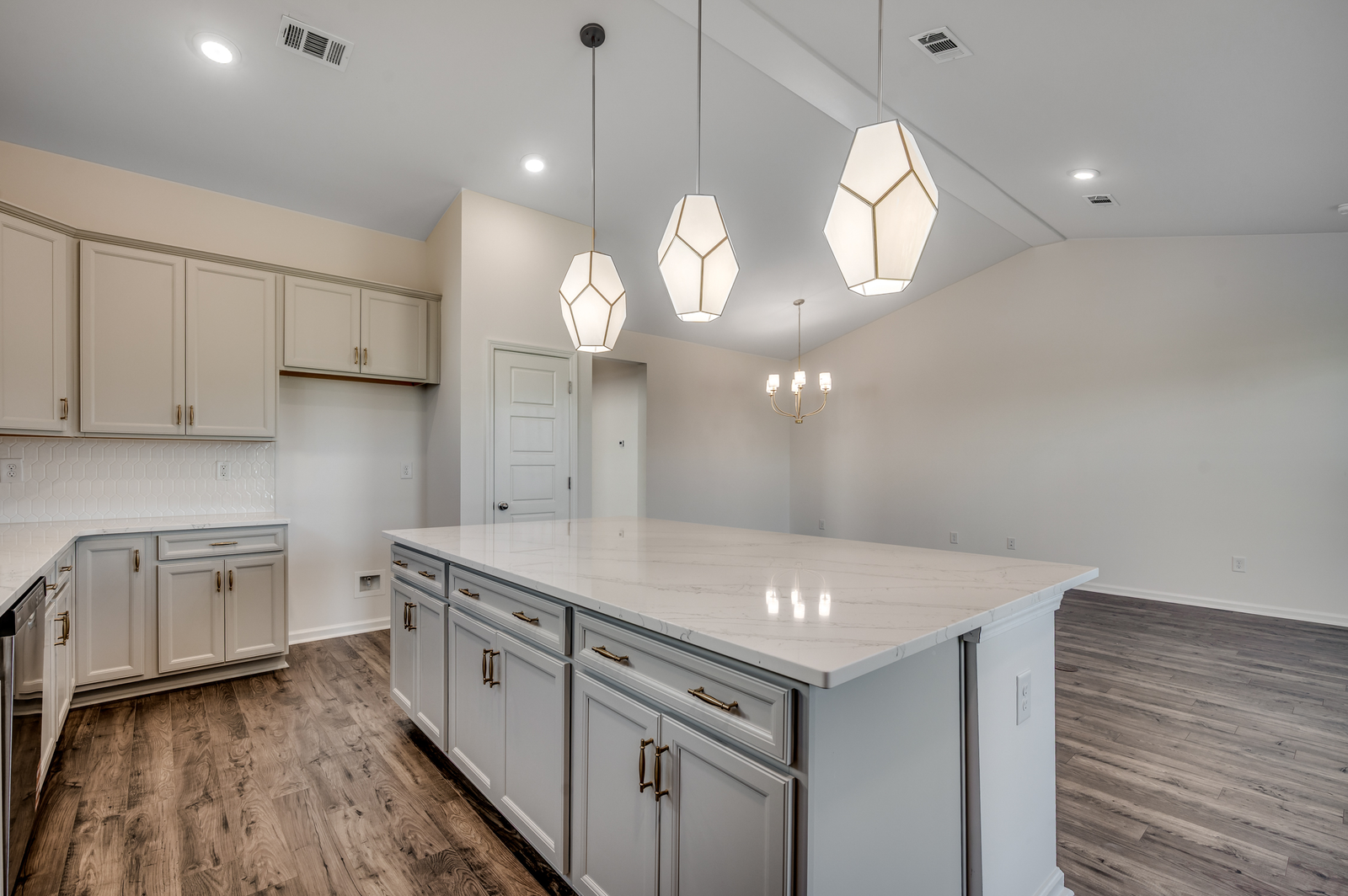 large island with pendant lighting and gold hardware