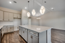 large island with pendant lighting and gold hardware 