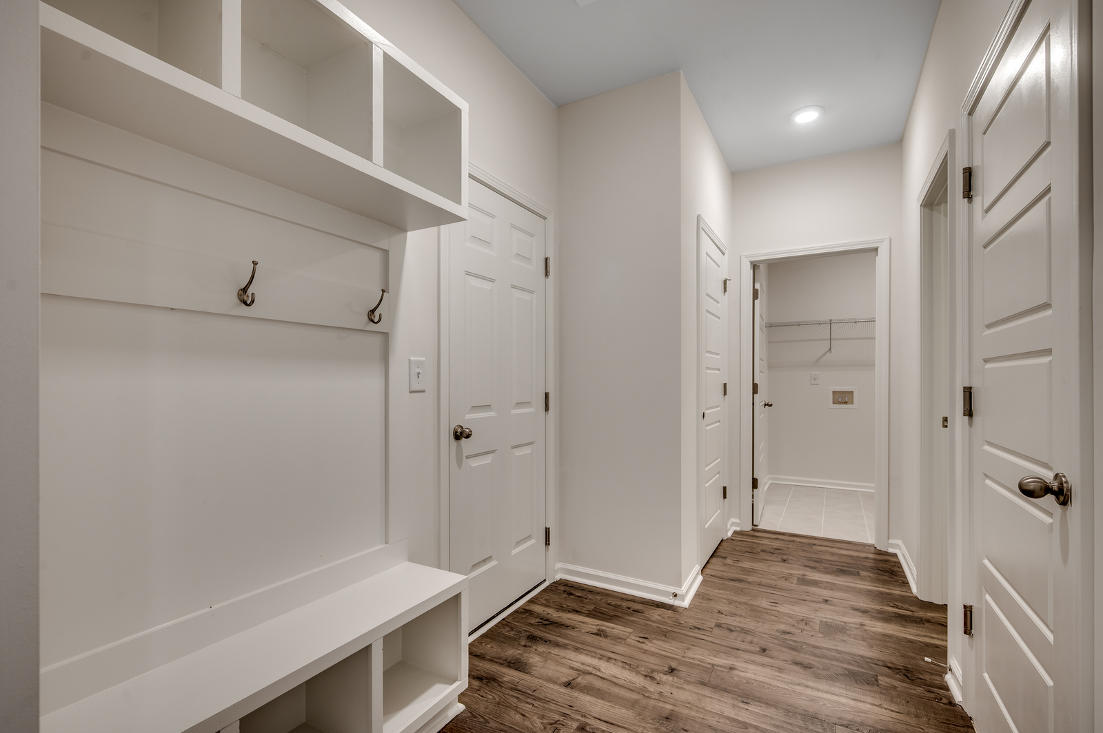 bright white built in shelving with space for storage and seating area