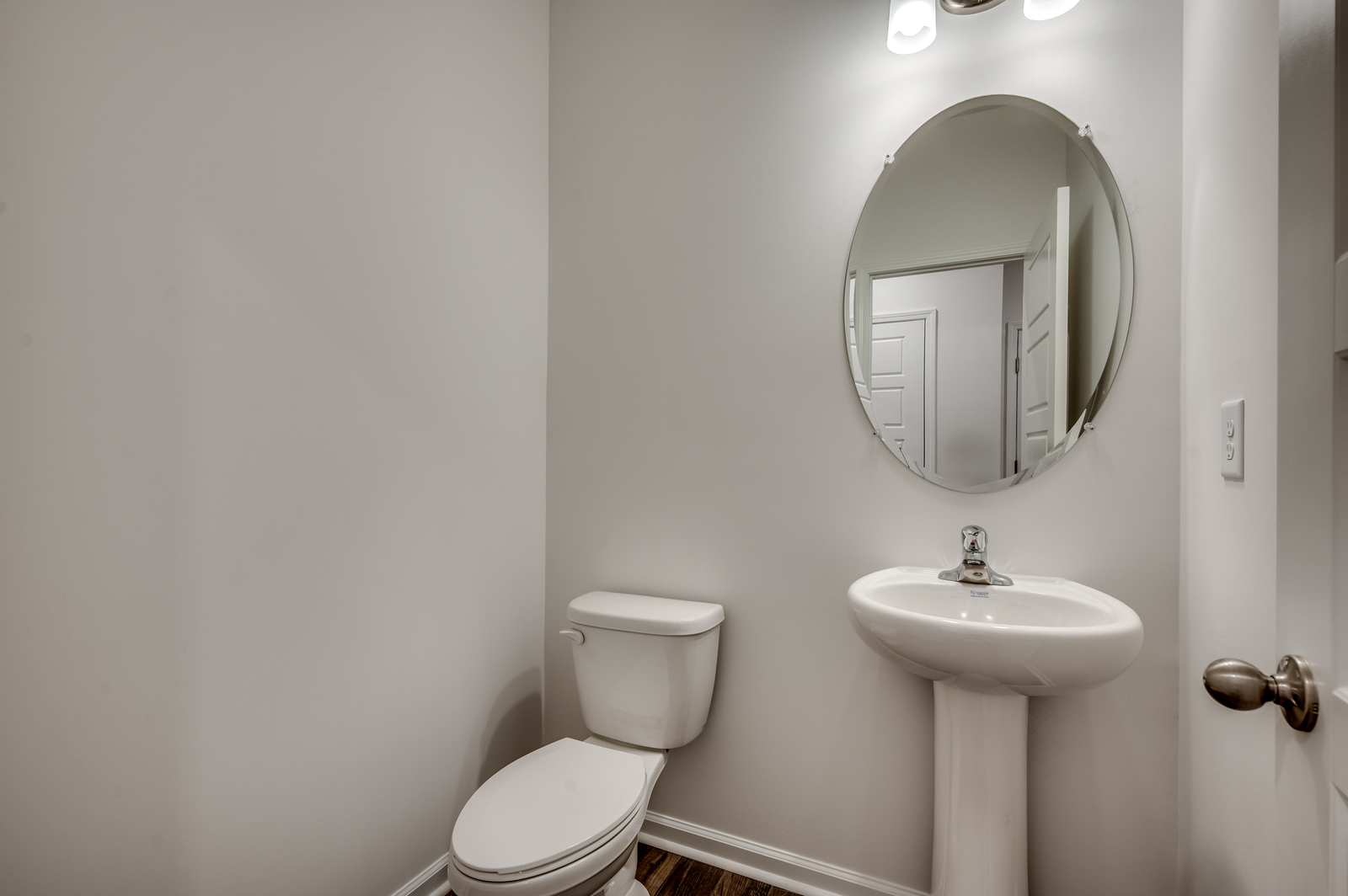 tan walls, large mirror and single sink vanity