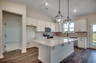 open-concept island with white quartz countertops and stainless steel appliances