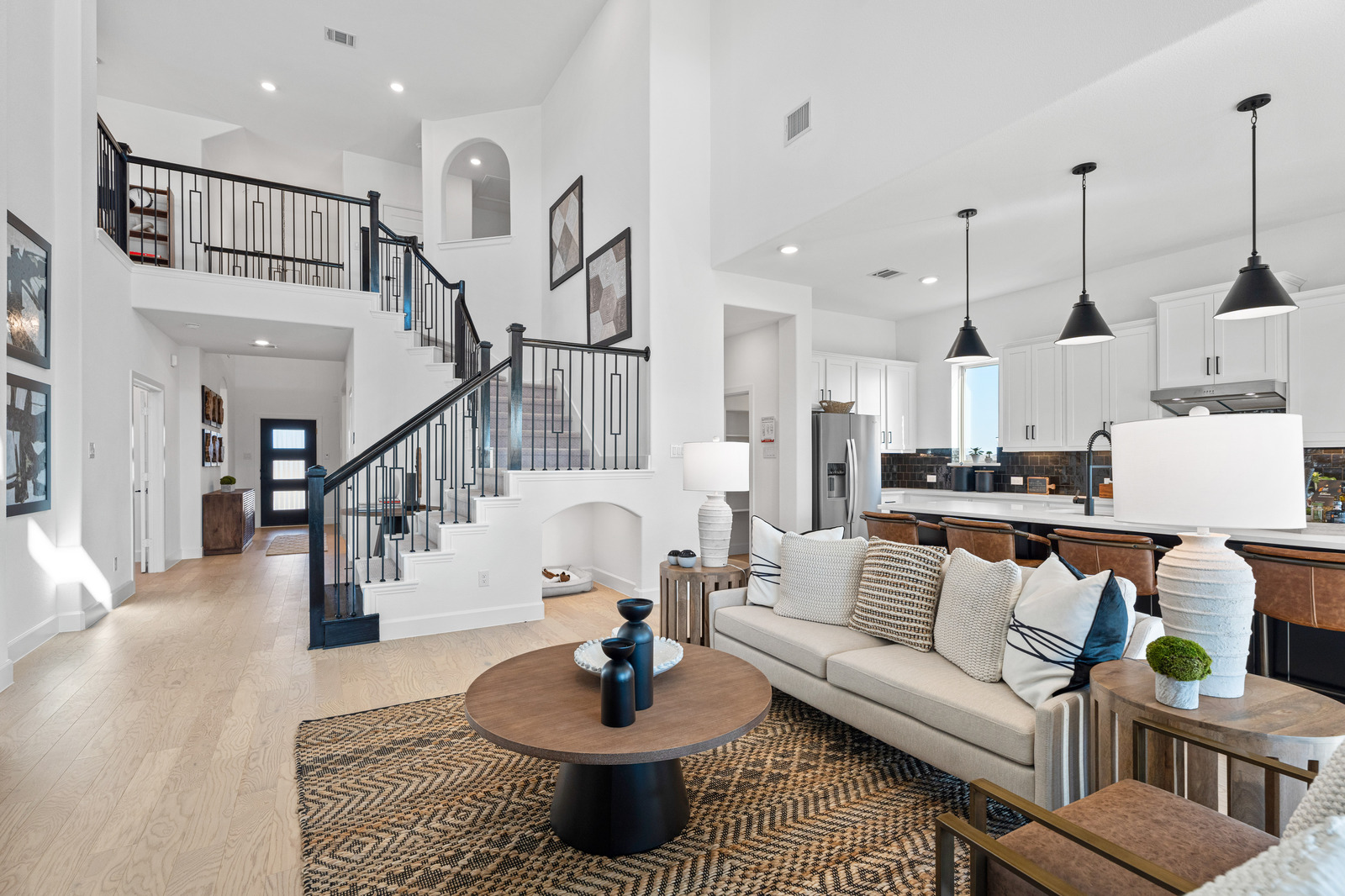 great room with wood floors and tall ceilings 
