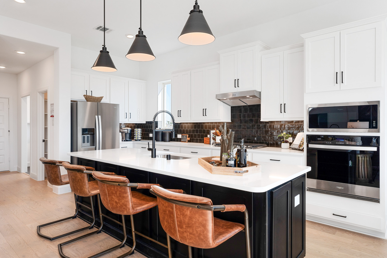 open kitchen with white cabinets and wood floors