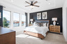 primary bedroom with carpet and ceiling fan