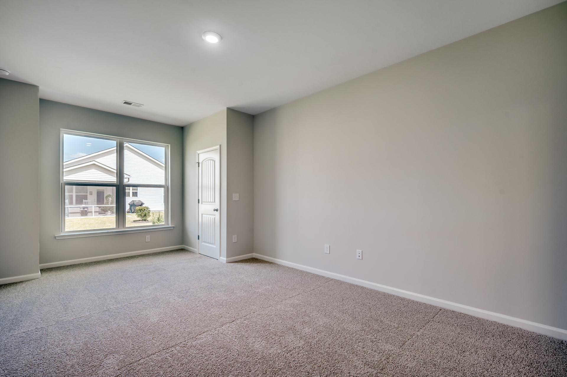 large room with carpeting throughout and window for natural lighting