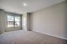 large room with carpeting throughout and window for natural lighting