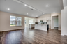 open-concept room with high ceilings and hardwood flooring throughout 
