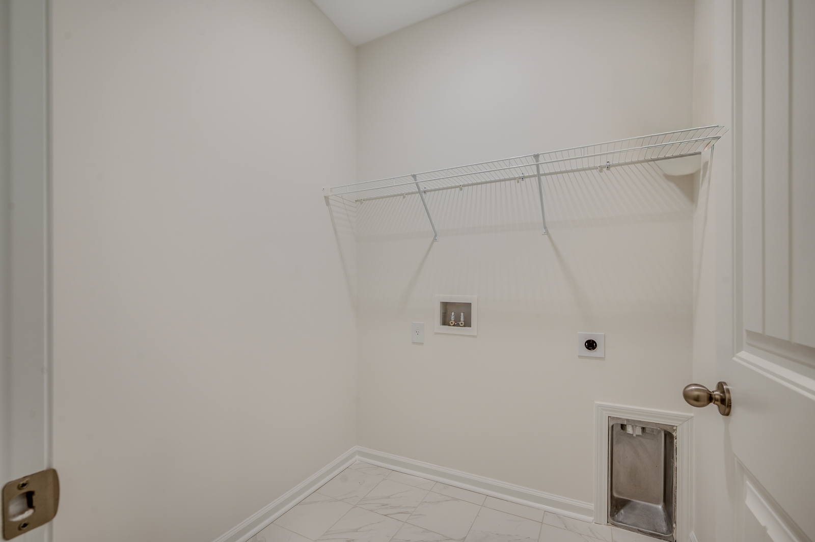 white wire shelving, white wall and tile flooring throughout