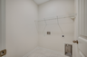 white wire shelving, white wall and tile flooring throughout 
