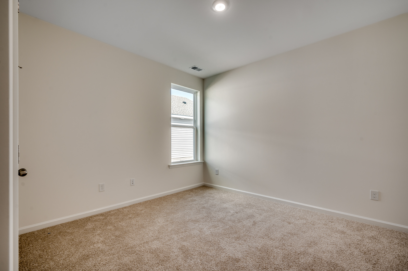tan carpeting and windows for natural light