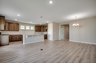 open-concept area with large kitchen island and hardwood flooring 