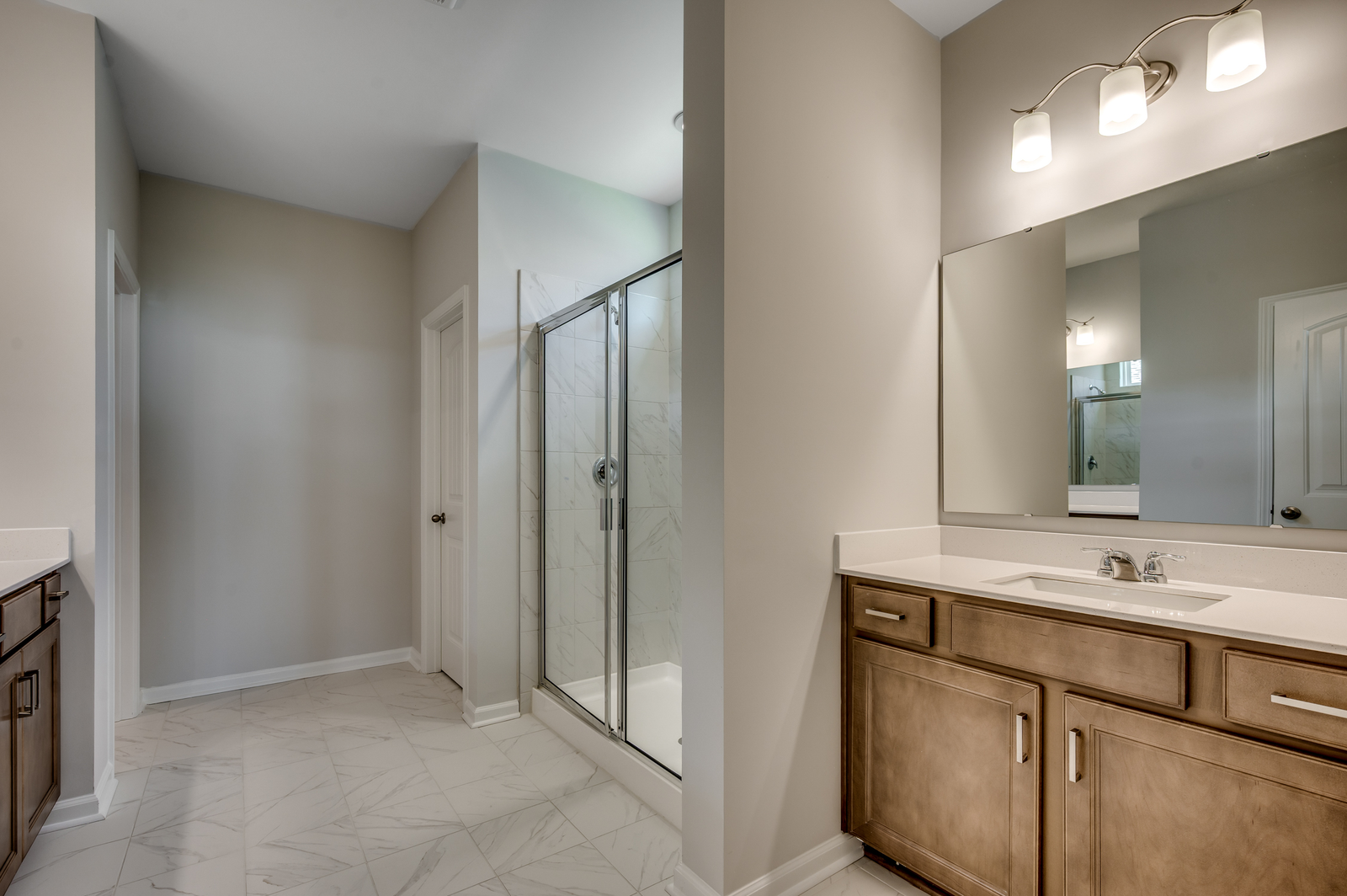 dark brown single sink vanity with walk-in shower and tile flooring