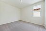 bedroom with neutral carpet and large window