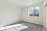 bedroom with neutral carpet and large window