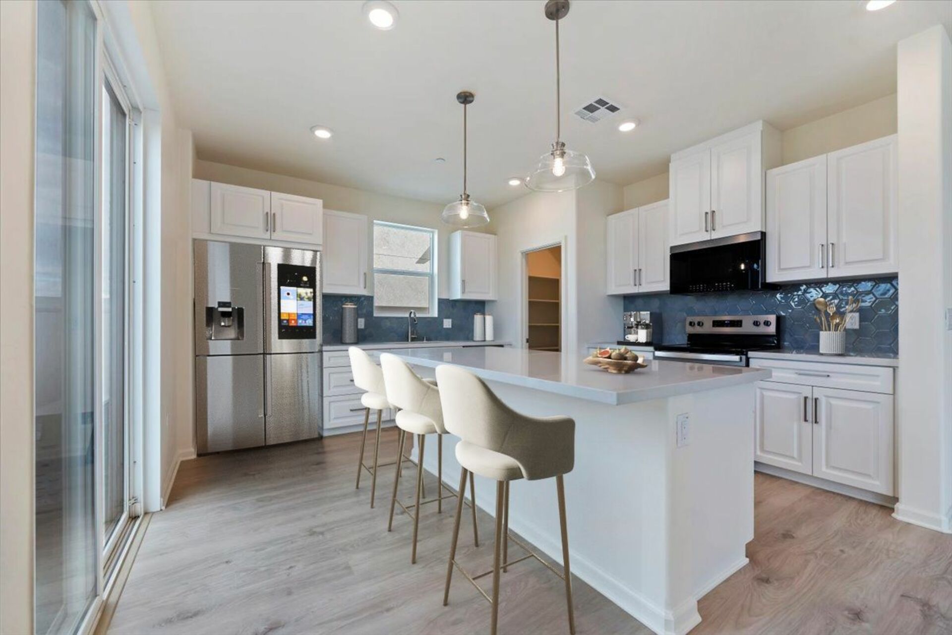 kitchen with white cabinets and blue backsplash
