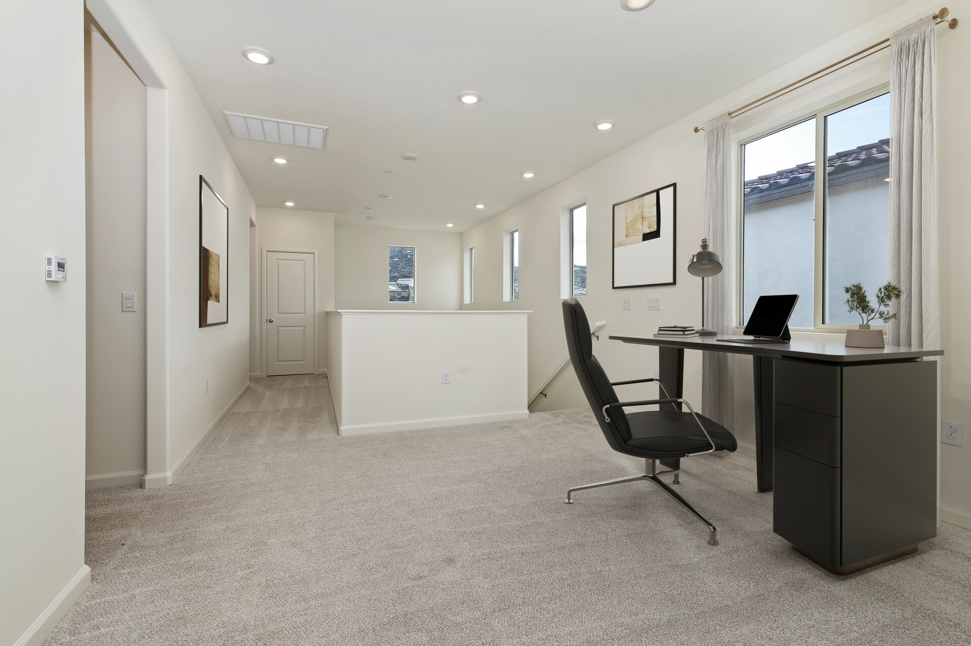 loft with a desk and swivel chair