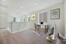 loft with neutral carpet and large windows