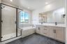 primary bathroom with a walk-in shower and a separate soaking tub