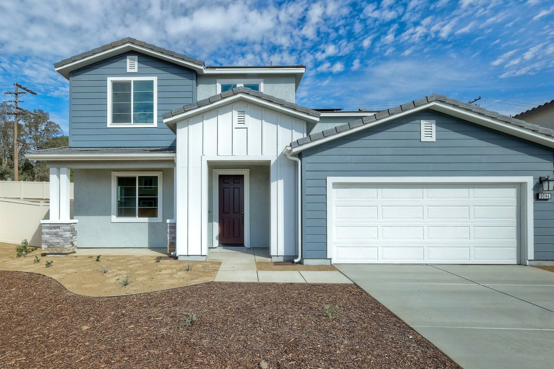 multicolored exterior with a white windowless garage