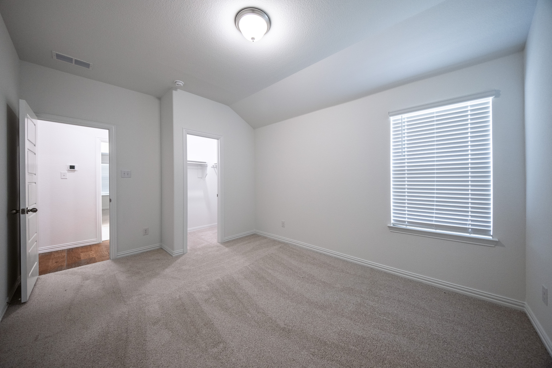 guest bedroom with carpet and walk-in closet
