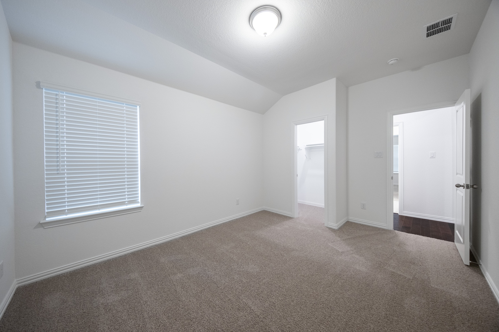 guest bedroom with walk-in closet
