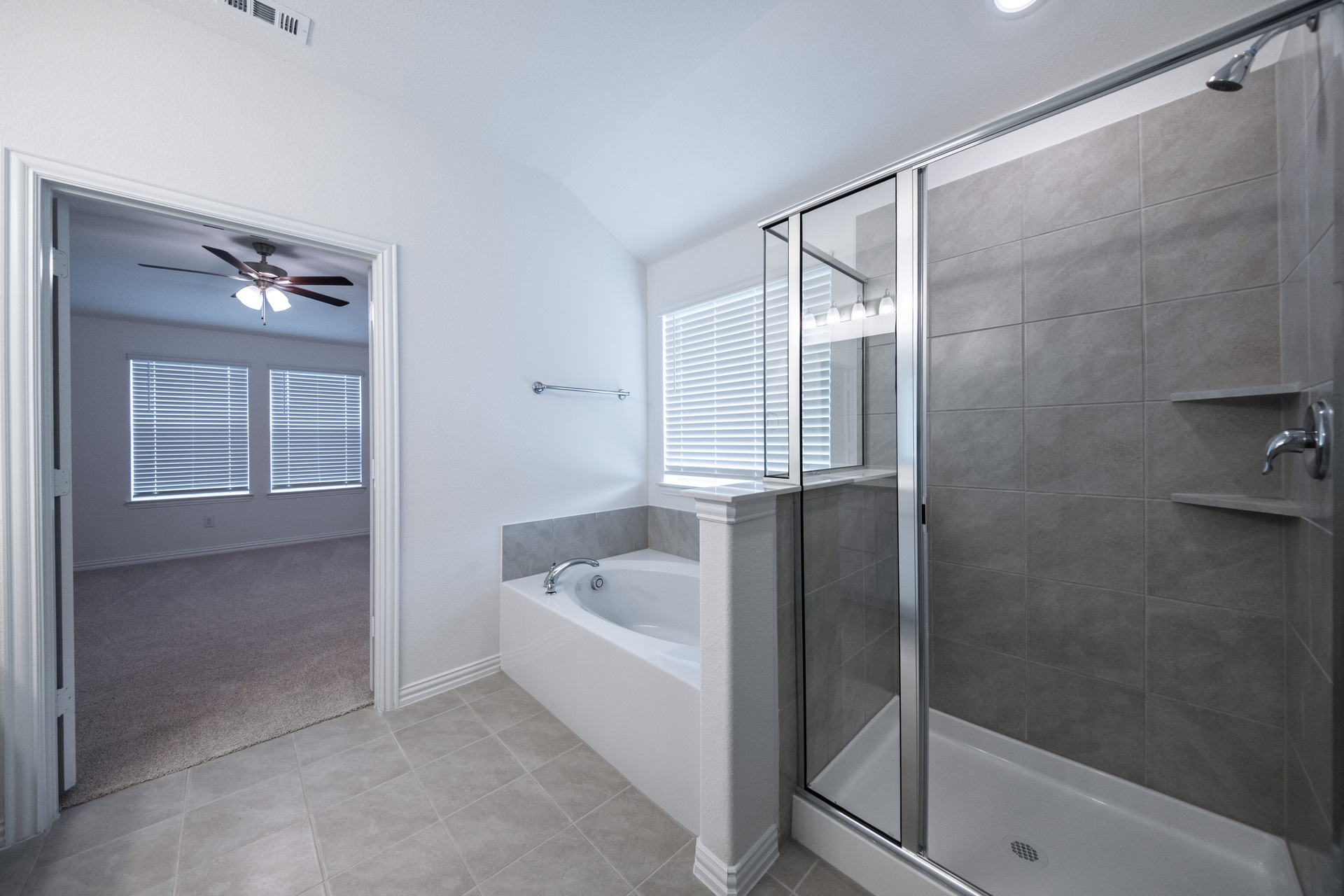 primary bathroom with separate walk-in shower and soaking tub