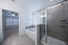 primary bathroom with separate walk-in shower and soaking tub
