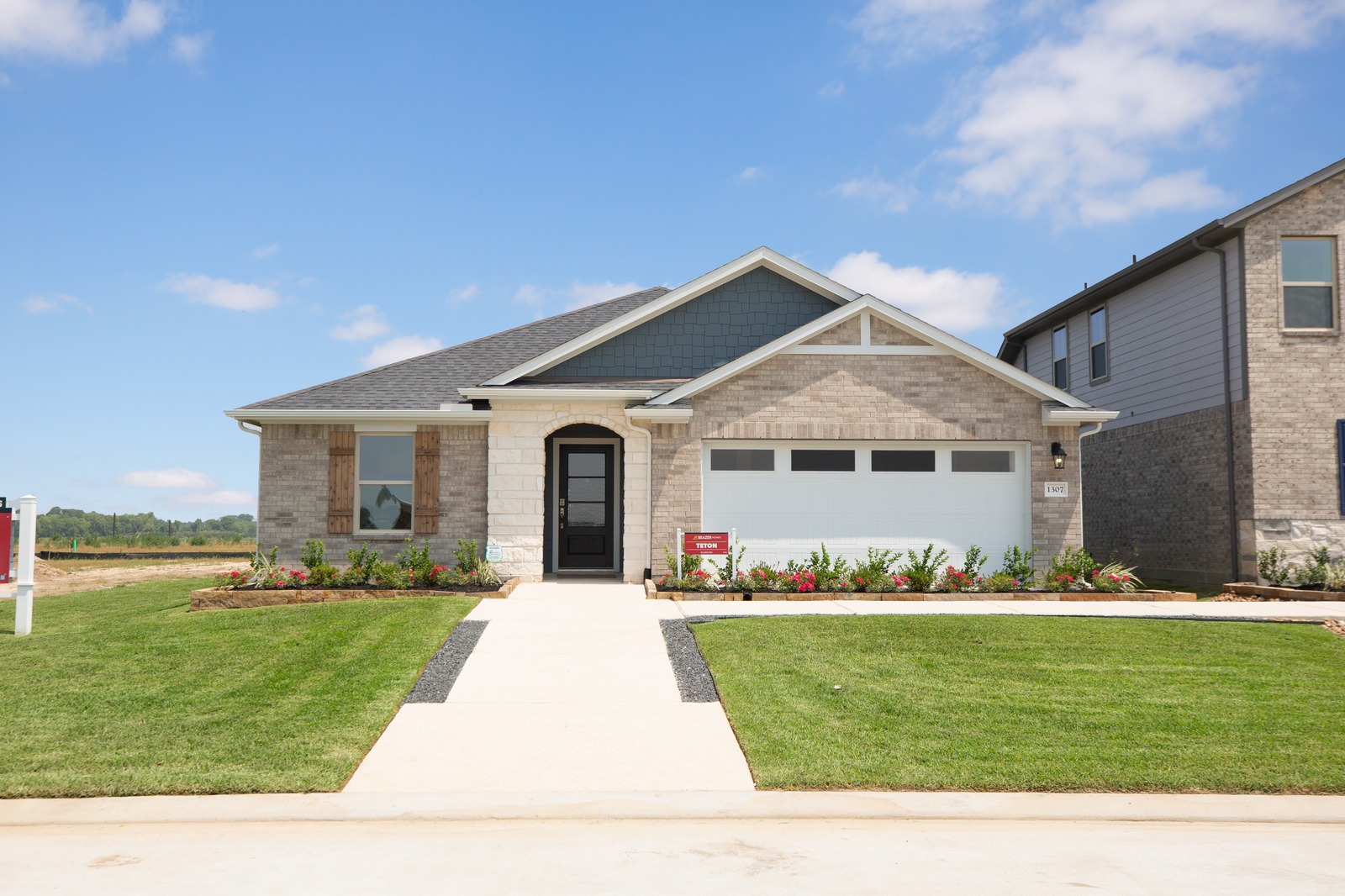 home exterior with brick and lush landscaping