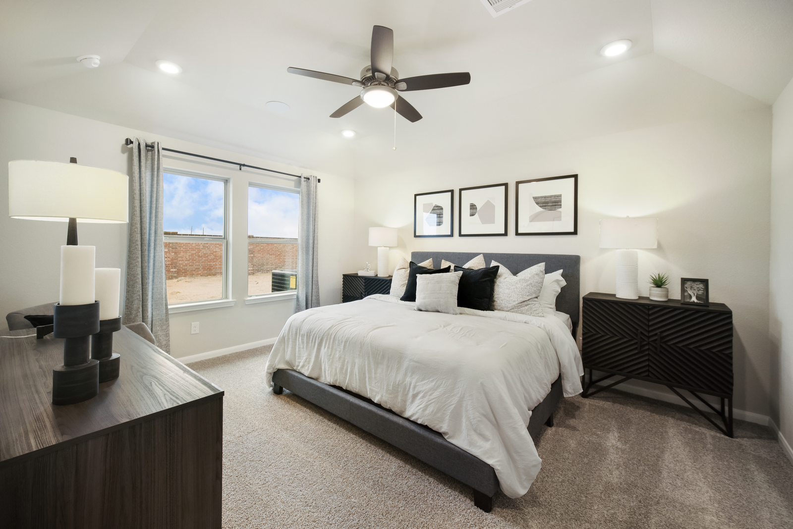 primary bedroom with wall art and nightstands