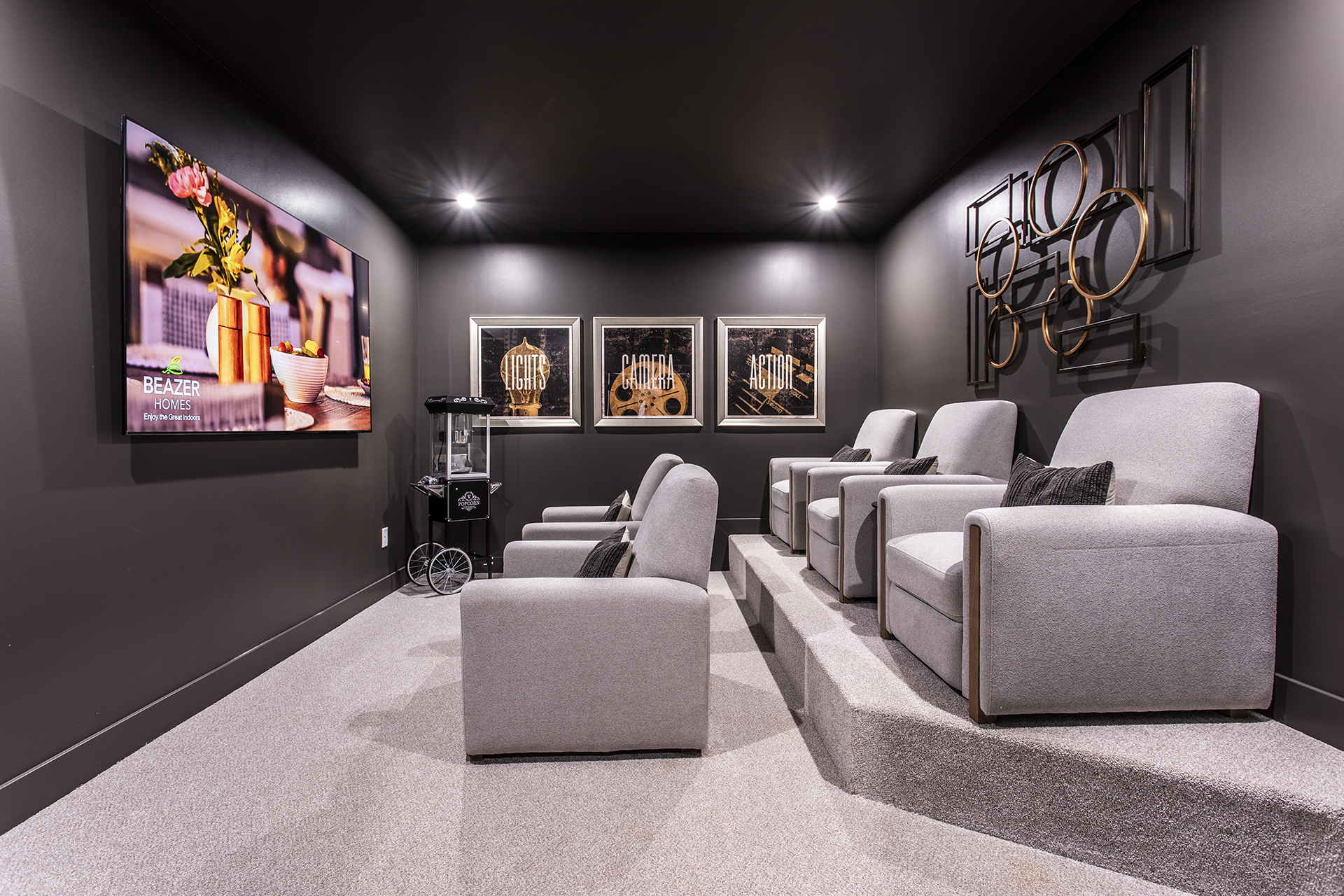media room in basement with seating and oversized tv