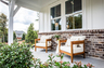 front porch with outdoor furniture & brick detail