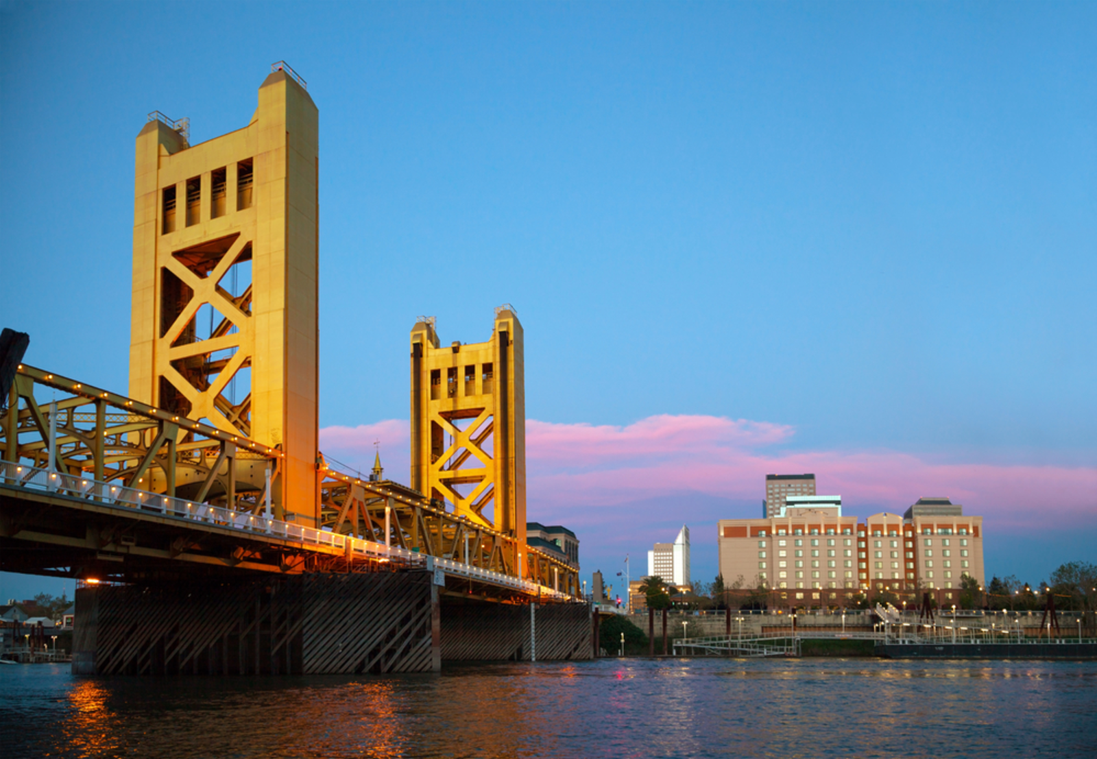 gold bridge over river at sunset