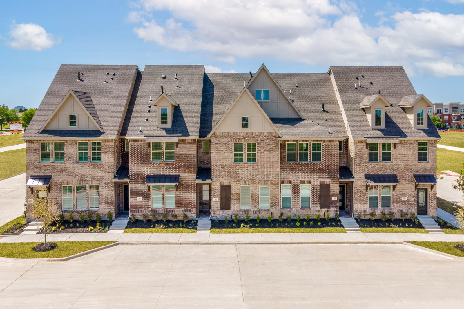brick townhome exterior with covered front porches