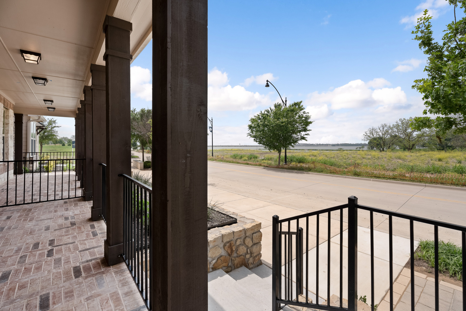 porch view of lake ray hubbard and grassy area