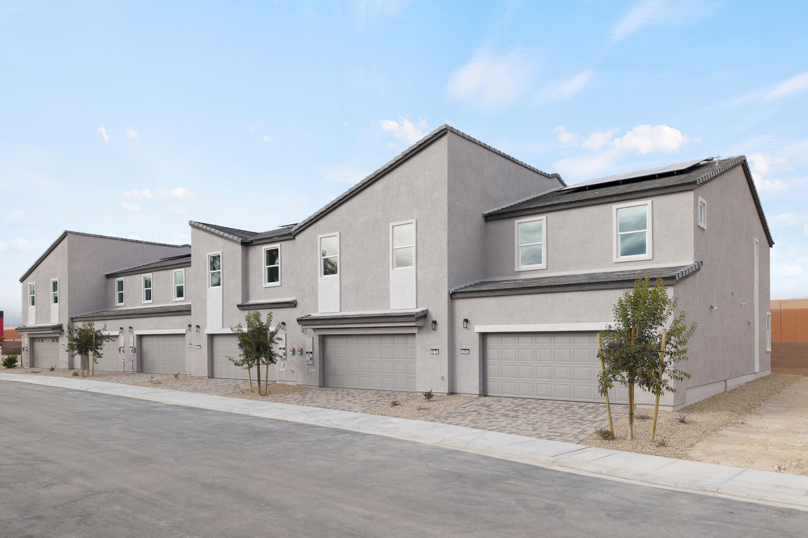 two-story townhome with brick driveway pavers