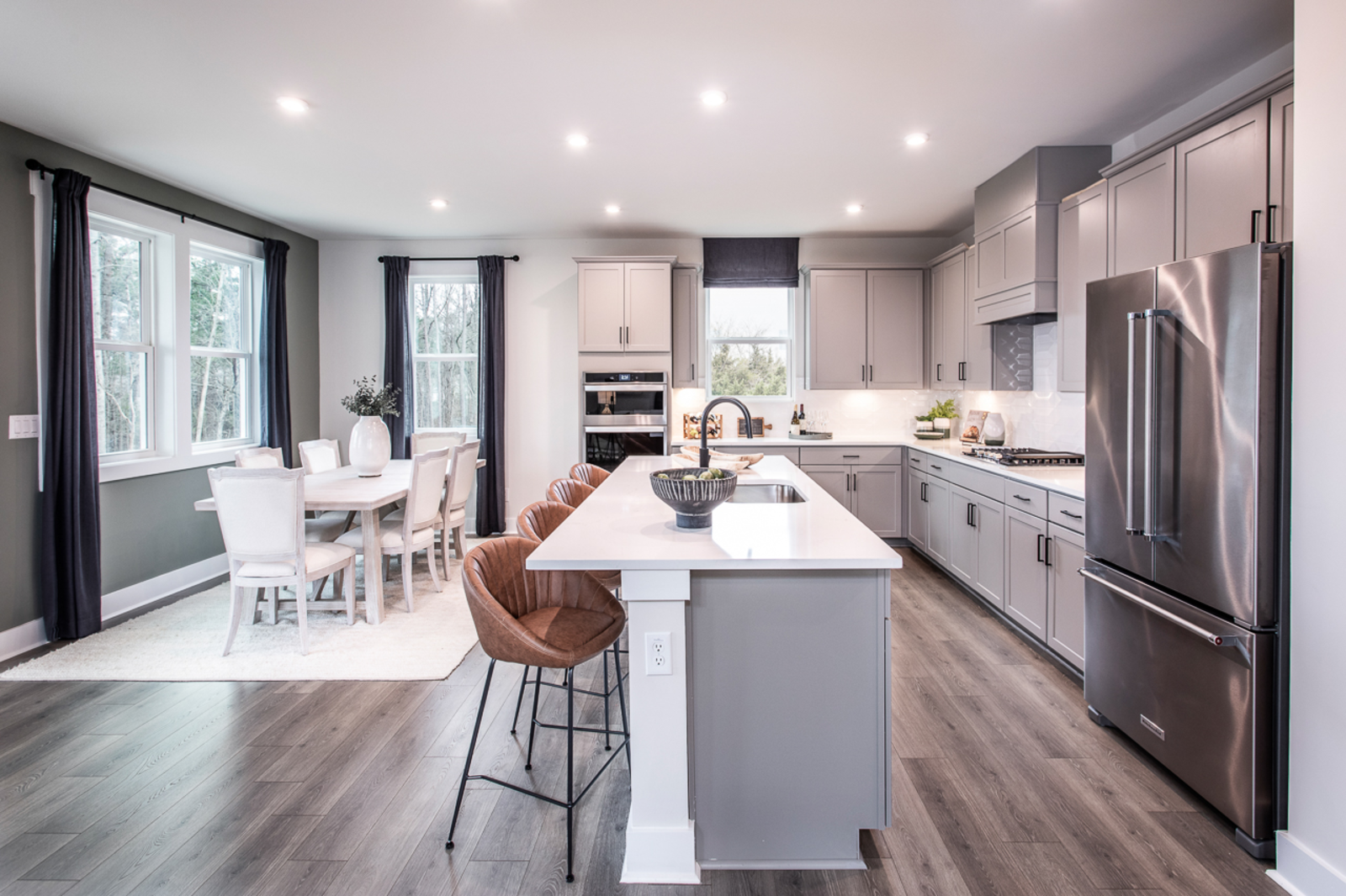 kitchen with gray cabinets open to breakfast room 