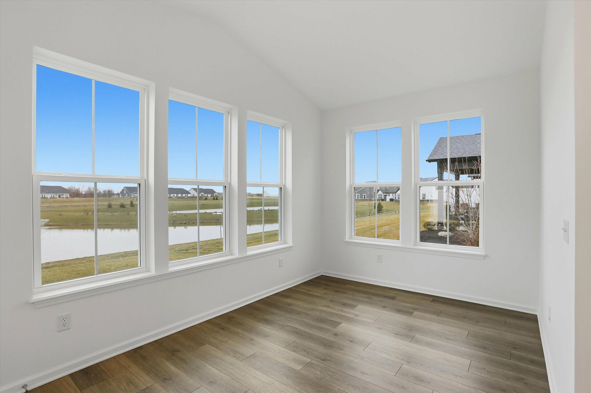 morning room with cathedral ceilings and five windows letting in light 