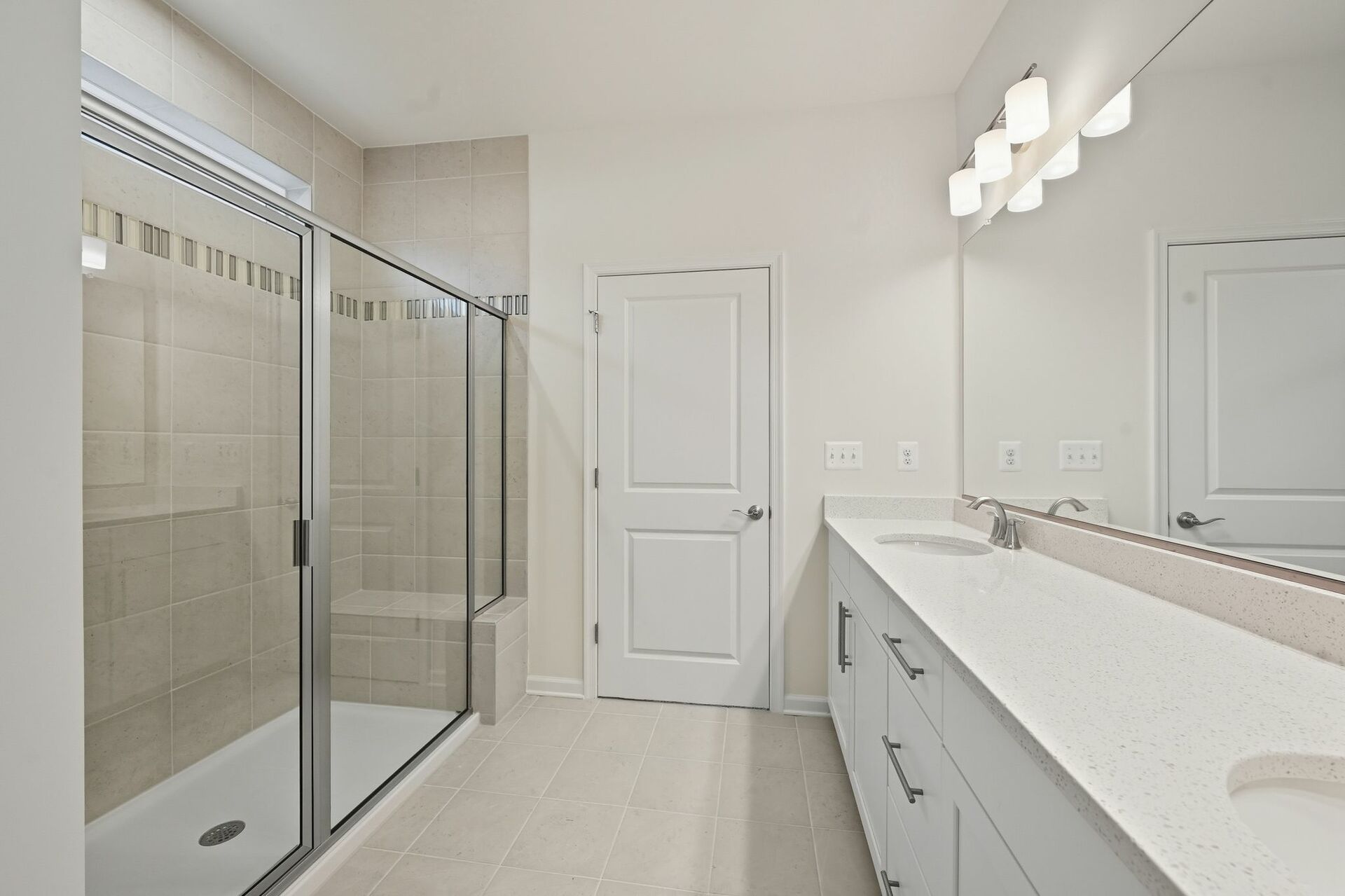 primary bath with a large walk-in shower with a seat