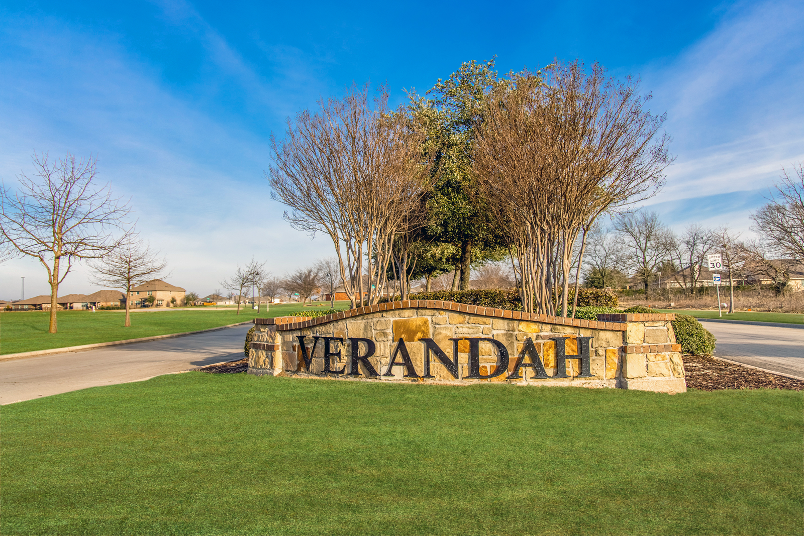neighborhood entrance sign with brown stone