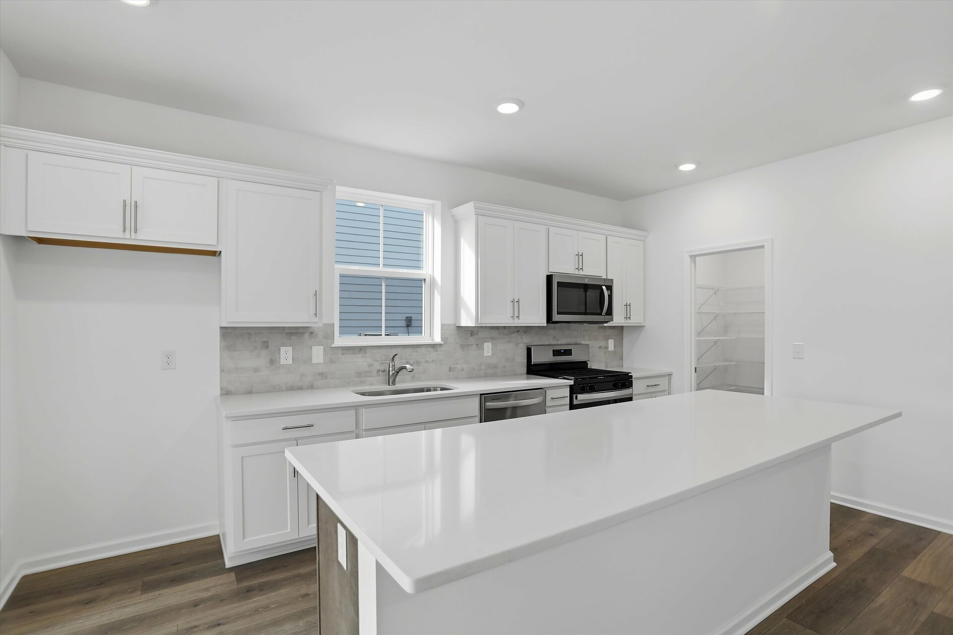 kitchen with white cabinets and large island