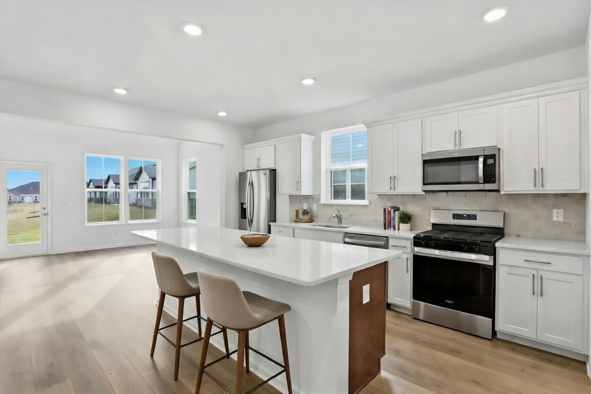 kitchen with an island that has barstools and white cabinets