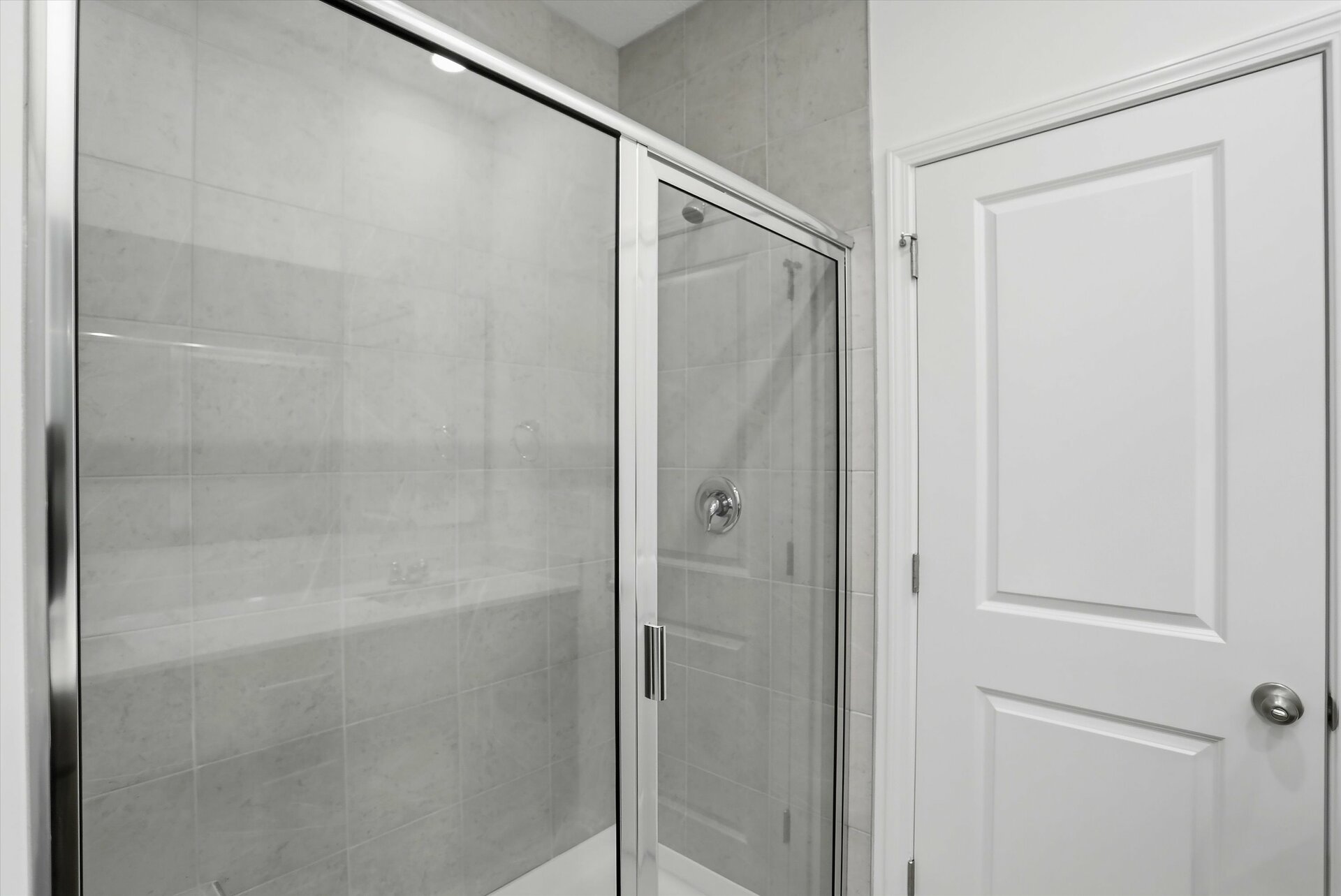 frameless glass walk-in shower with tiled walls