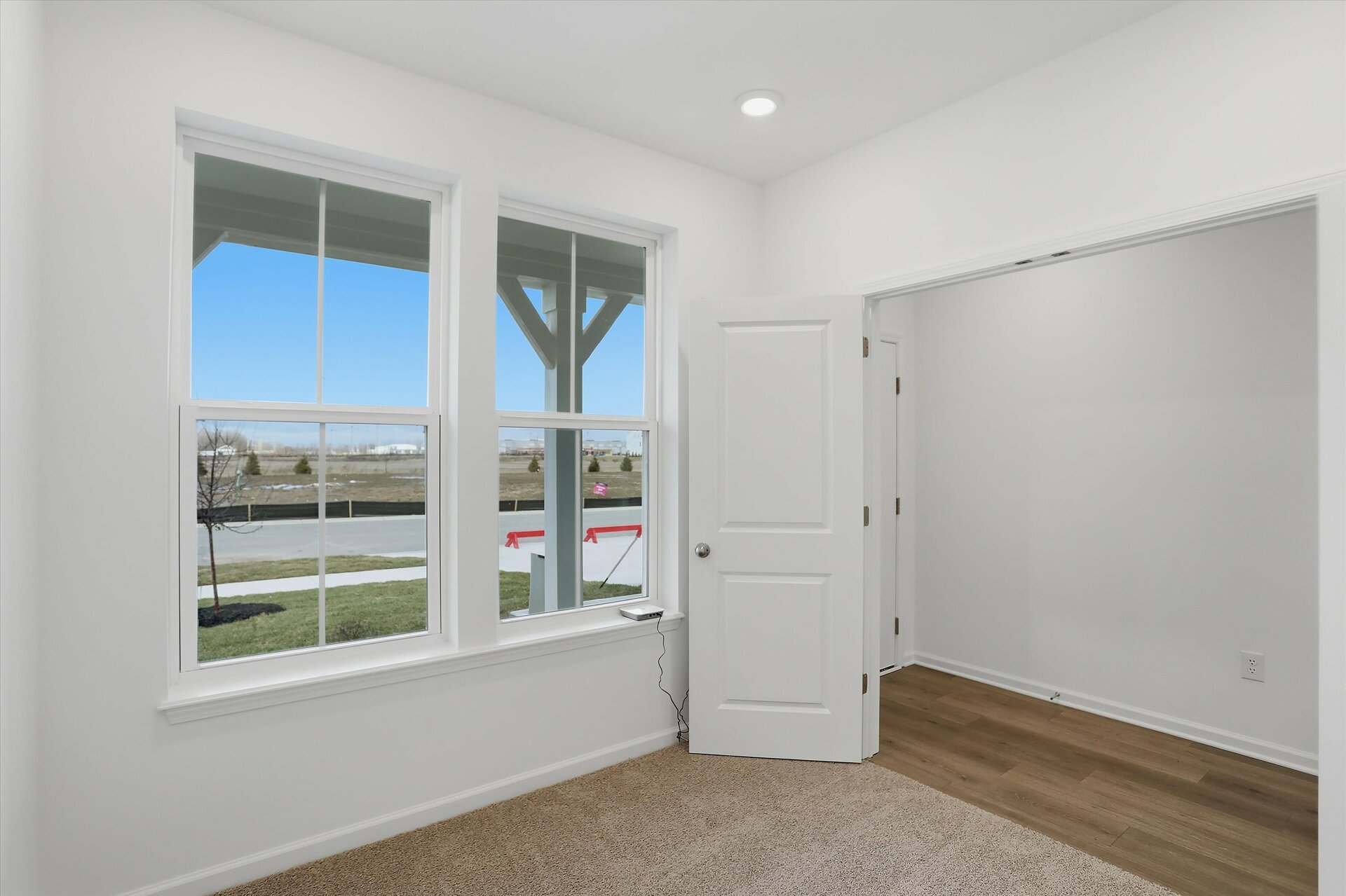 study with double french doors and tan carpets