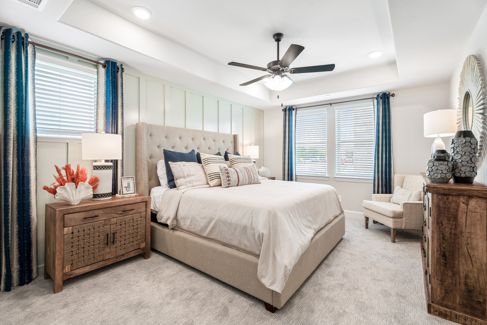 primary bedroom with carpet and ceiling fan